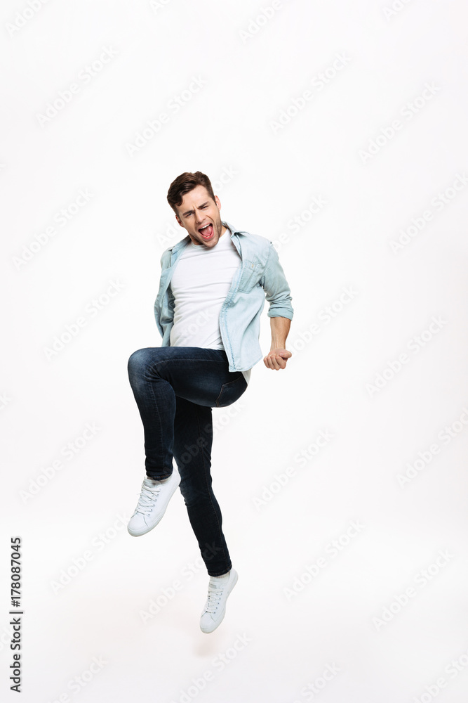 Full length portrait of a satisfied happy man celebrating success Full length portrait of a satisfied happy man celebrating success