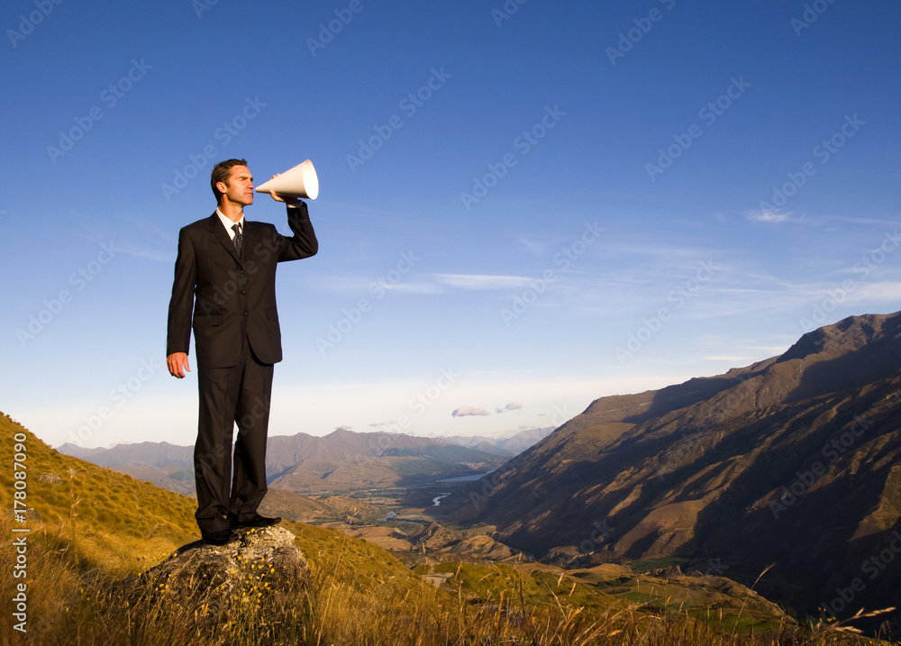 Businessman shouting on the top of the mountain. Businessman shouting on the top of the mountain.