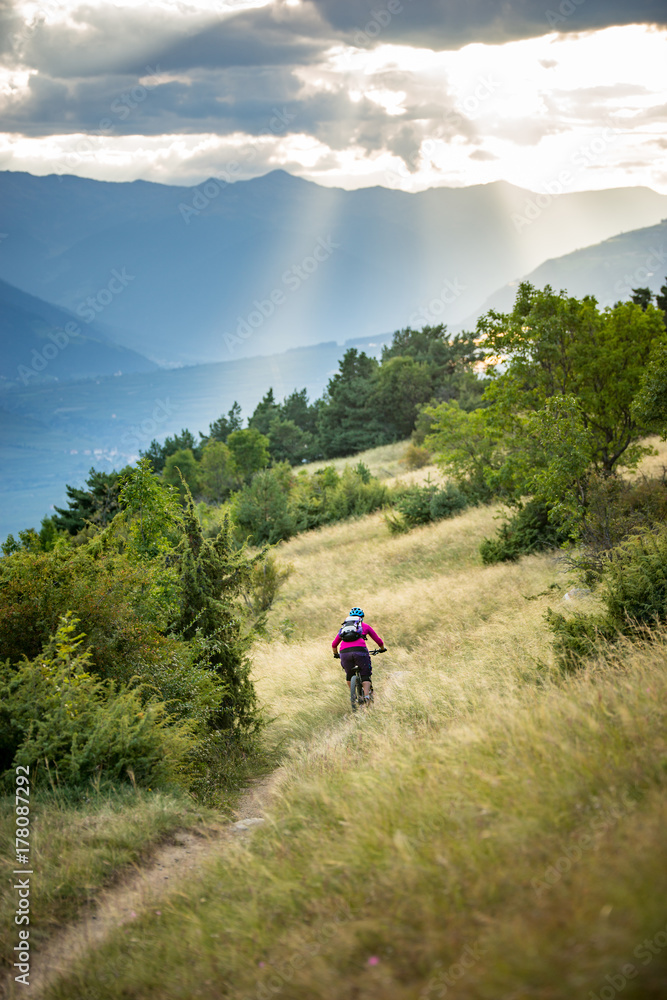 Woman riding mountain bike on slope Woman riding mountain bike on slope