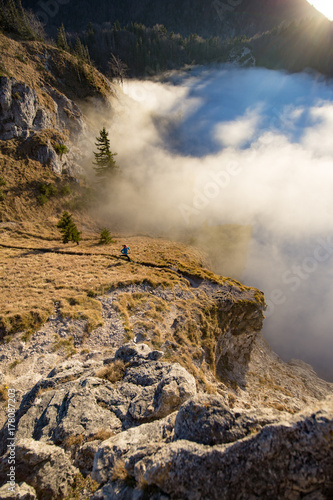 A young woman does mountain running or a trail run at the beautiful Nockstein mountain in Salzburg, Austria.