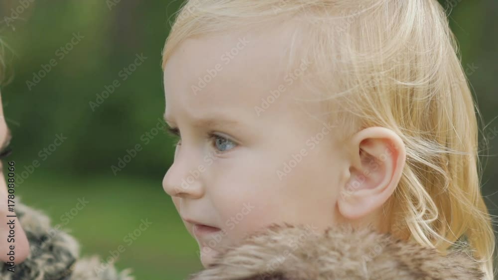 Portrait of pretty blue-eyed kid looks around. Slowly Portrait of pretty blue-eyed kid looks around. Slowly