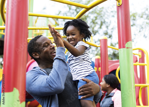 African father and child on a park photo