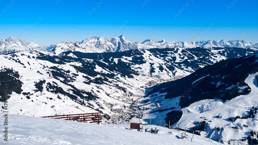 Panoramic view of winter mountains. Alpine peaks covered by snow.