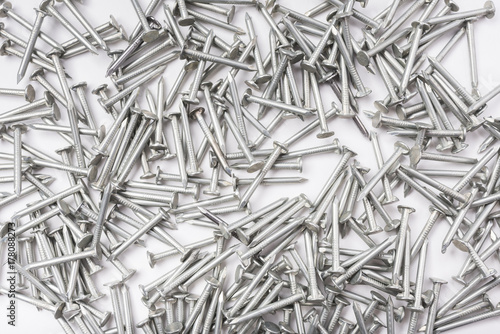 Many metal nails on white background