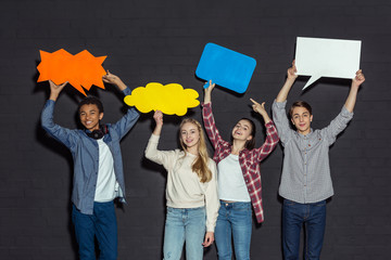 teenagers holding blank speech bubbles
