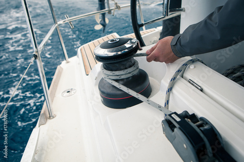 Sailor pulling rope, outdoor activities, sailboat sport race