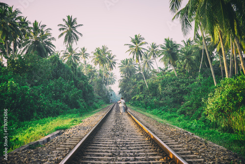 One woman goes by railroad in the jungle