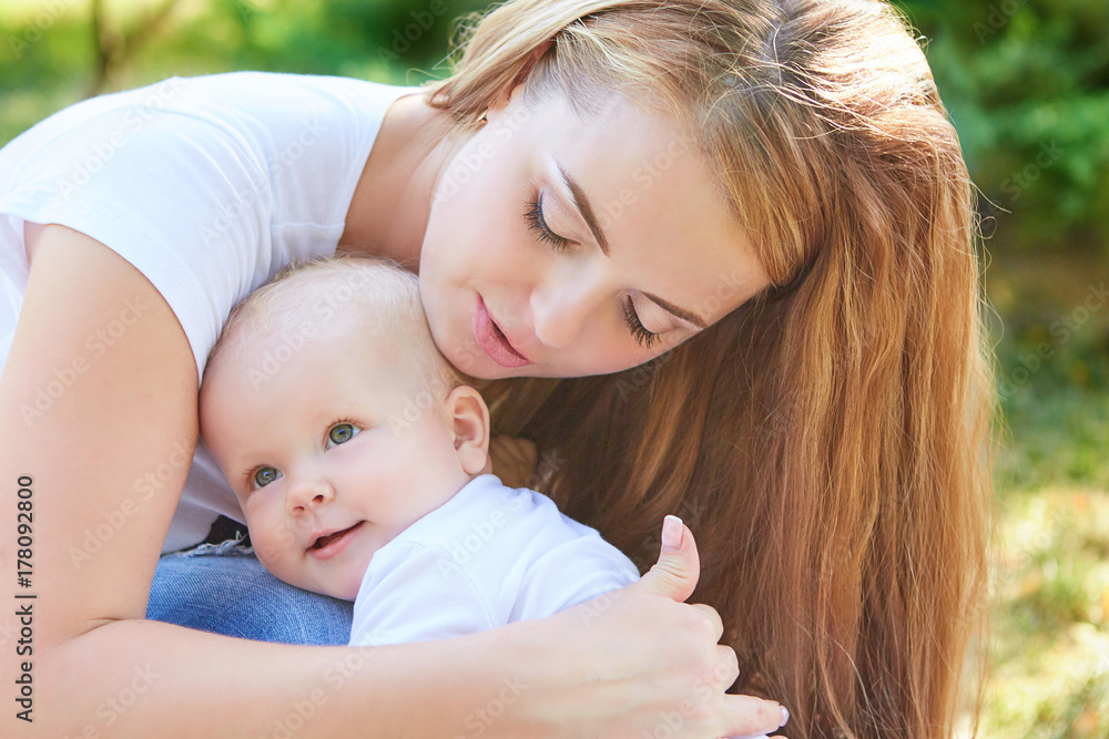Happy beautiful mother and baby daughter or son Happy beautiful mother and baby daughter or son