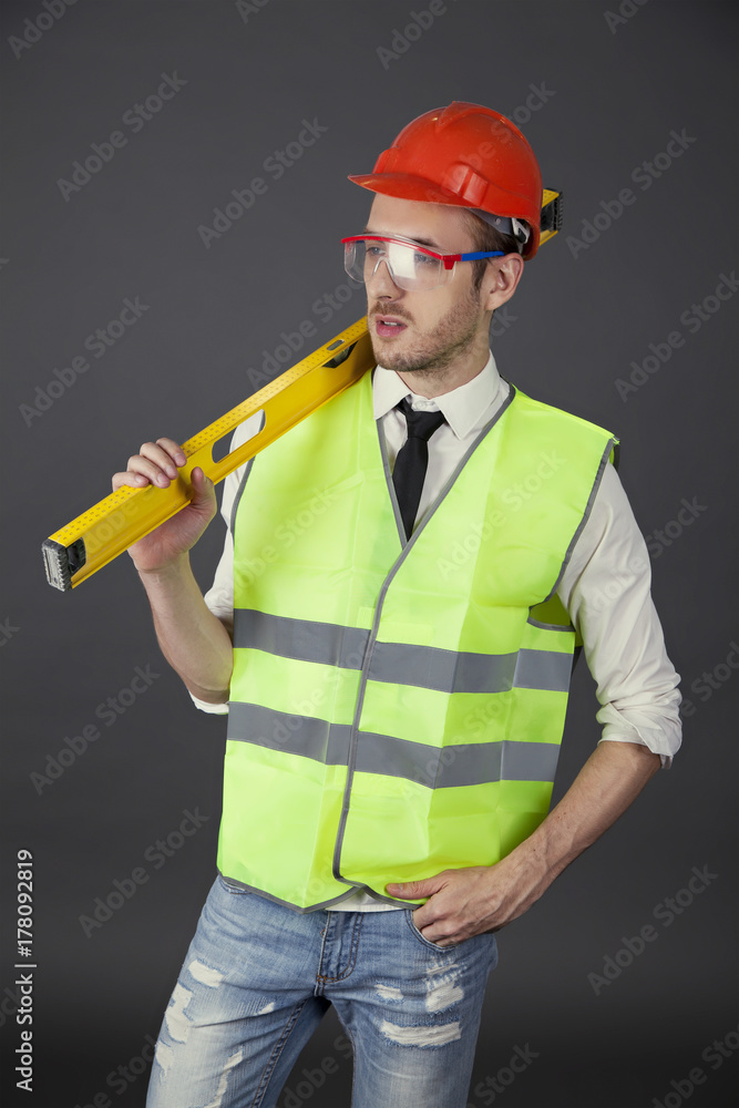 Builder on a gray background with level Builder on a gray background with level