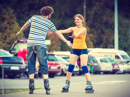 Young couple on roller skates riding outdoors © anetlanda