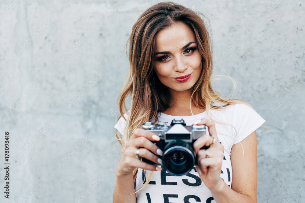 Stylish woman photographer in white T-shirt with word Stylish woman photographer in white T-shirt with word