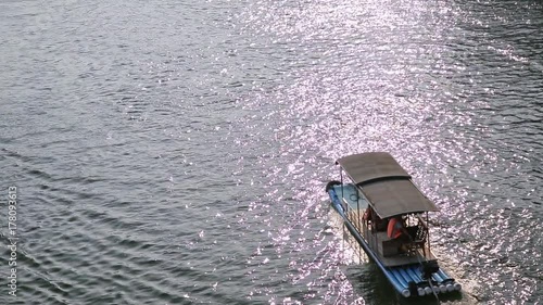 Handheld shot of beautiful Yu Long river Karst mountain landscape in Yangshuo. Maby small raft boats floating at sunset. photo