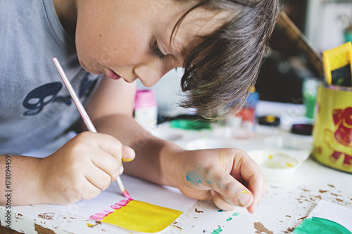 close up of a young boy / child painting photo