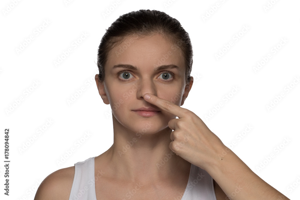 Massage, yoga, gymnastics or rejuvenating exercises for the face makes the girl own hands on a white background Massage, yoga, gymnastics or rejuvenating exercises for the face makes the girl own hands on a white background