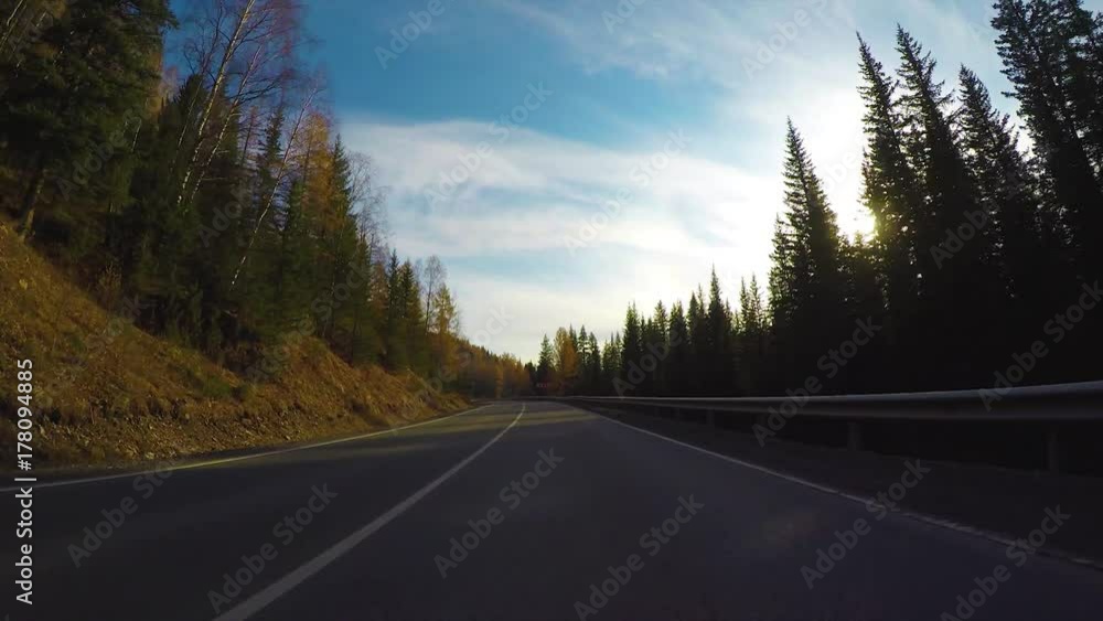 Driving down a quiet rural highway during the day in autumn. Driving down a quiet rural highway during the day in autumn.