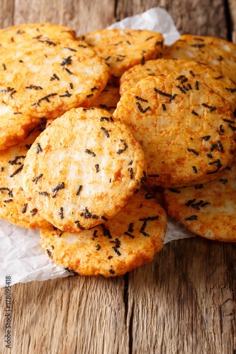 Japanese food: pepper rice crackers with seaweed and tapioca close-up. vertical