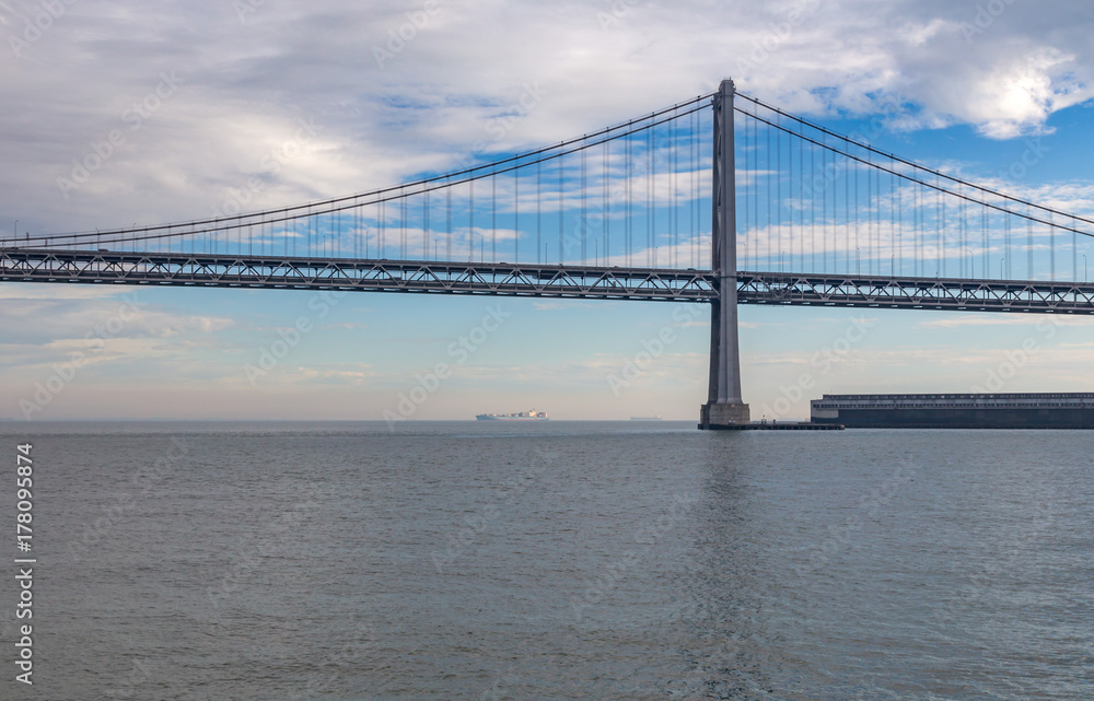Bay Bridge, San Fransisco, America with cloudy sky and calm watr