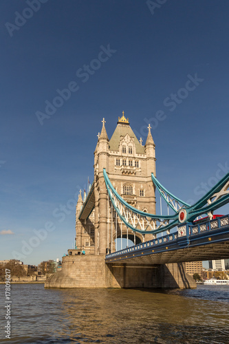 Tower Bridge  vertical shot with the river and a blue sky.