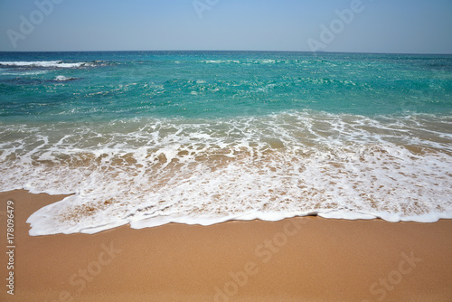 the waves of the Indian Ocean on a beautiful sand