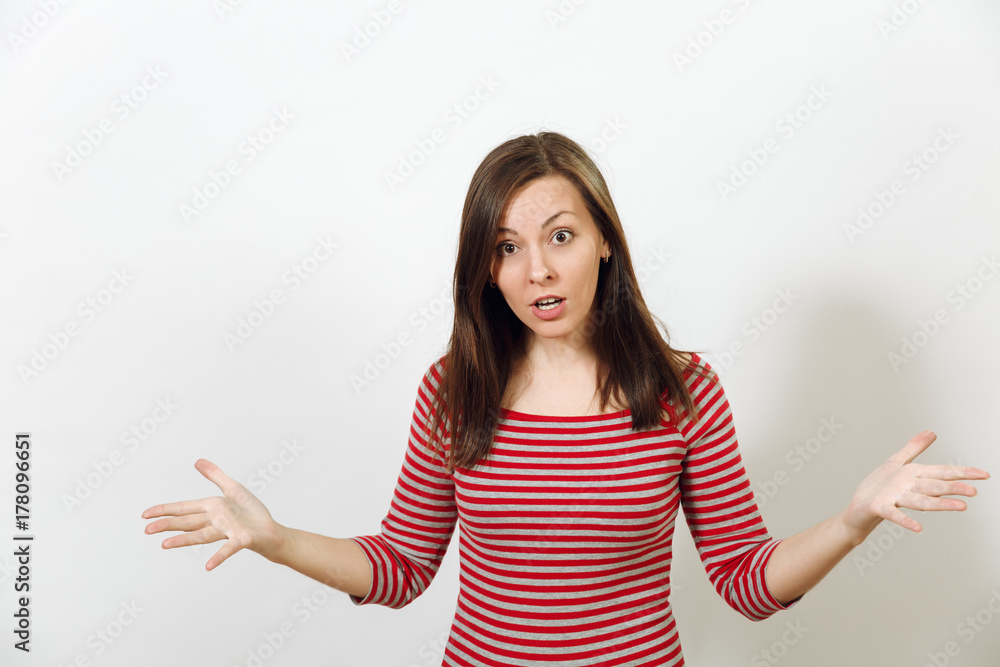 Pretty European young worried and pensive brown-haired woman with healthy clean skin, dressed in casual red and grey clothes lost in thought and conjectures, on a white background. Emotions concept. Pretty European young worried and pensive brown-haired woman with healthy clean skin, dressed in casual red and grey clothes lost in thought and conjectures, on a white background. Emotions concept.