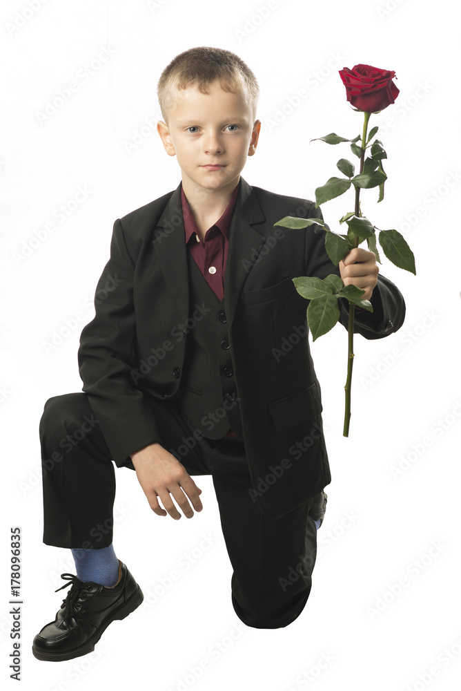 Boy with the red rose. Young man distinguished figure in a dark Boy with the red rose. Young man distinguished figure in a dark