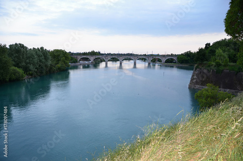 Fototapeta Naklejka Na Ścianę i Meble -  The Bridge and the River Mincio flowing into the Italian Lake Garda