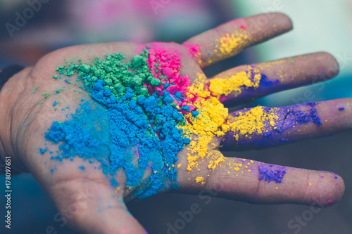 hand with different colors holi powder photo