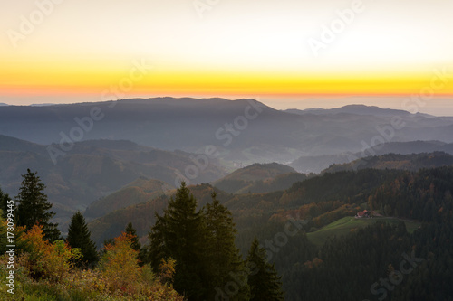 Fototapeta Naklejka Na Ścianę i Meble -  Autumn landscape - Black Forest. Panoramic view over the autumnal Black Forest, the Rhine valley and the Vosges (France) in the distance at sunset.
