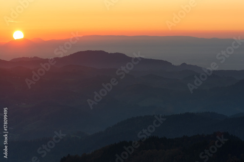 Autumn landscape - Black Forest. Panoramic view over the autumnal Black Forest, the Rhine valley and the Vosges (France) in the distance at sunset.