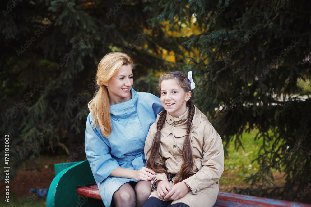 Fototapeta premium Mom with her daughter during autumn