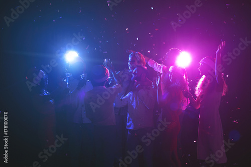 Group of friends at christmas party at night club © Prostock-studio