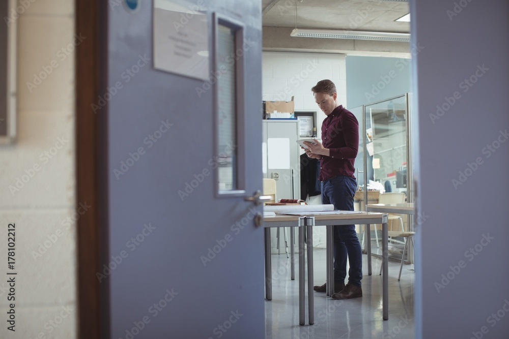Architect using digital tablet at table Architect using digital tablet at table