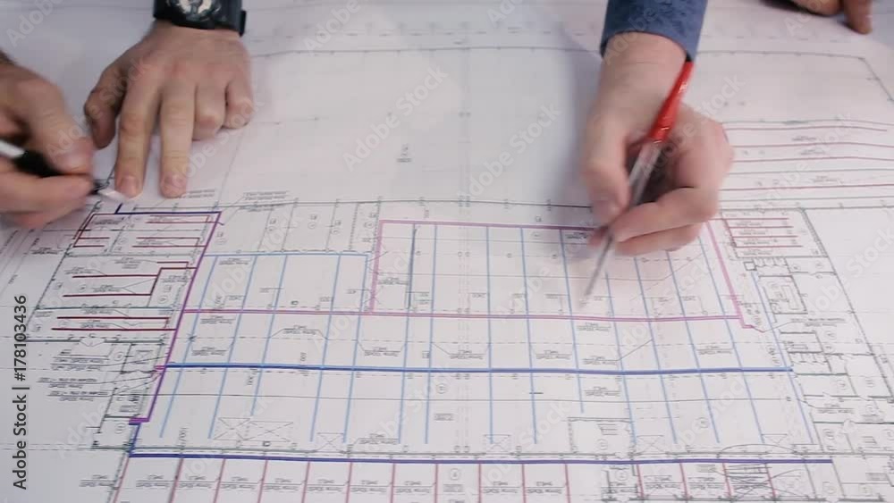 Engineer checks the data for the new project. Engineers are considering drawing