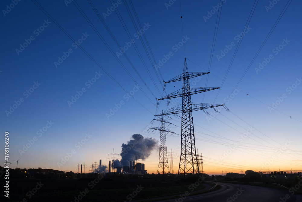 Electricity pylon and power plant in background