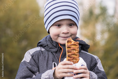 boy eats a cheese roll