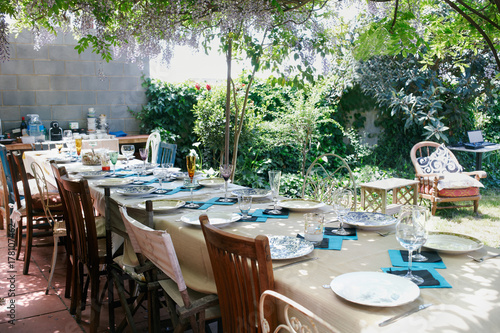 Table setting for an open air lunch in a garden photo