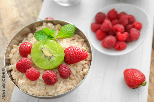 Tasty oatmeal with fruits in bowl  close up