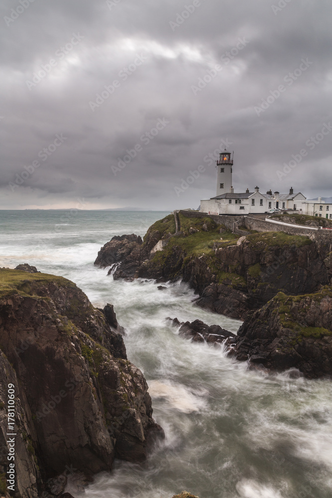 Lighthouse on the cliff on a stormy afternoon Lighthouse on the cliff on a stormy afternoon