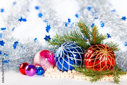 Christmas decorations and fir branches on white background with defocused tinsel