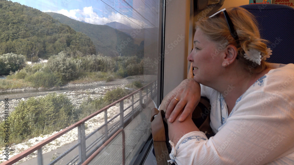 A woman travelling by train .