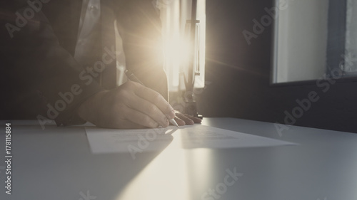 Retro image of businessman in office signing contract