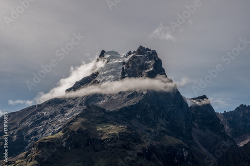 A mountain peak with ring of cloud around it photo