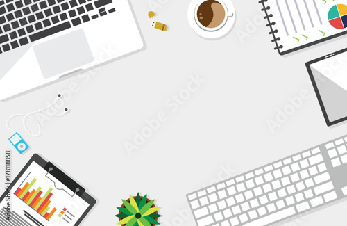 Top view of table working and working desk and free space for text with accessory on the table, laptop, notebook, keyboard, phone, pen, coffee cup, flowerpot, flash drive, note