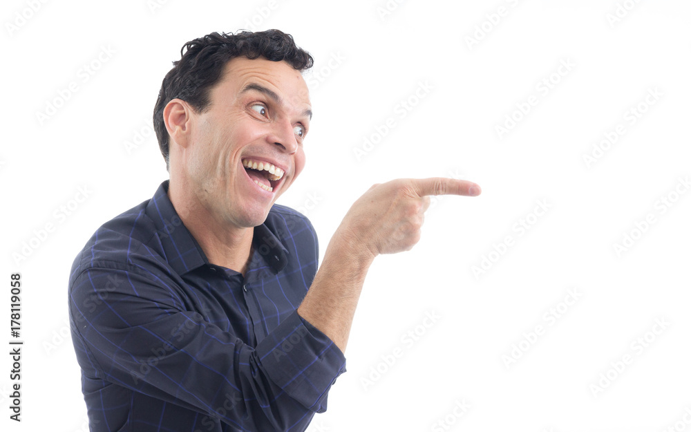 Enthusiastic man is pointing his finger to the side. The person is wearing dark blue social shirt. Isolated.. Enthusiastic man is pointing his finger to the side. The person is wearing dark blue social shirt. Isolated..