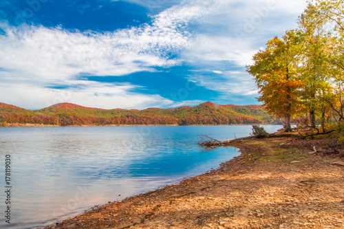 Autumn season at lake with beautiful forest at hill shore.