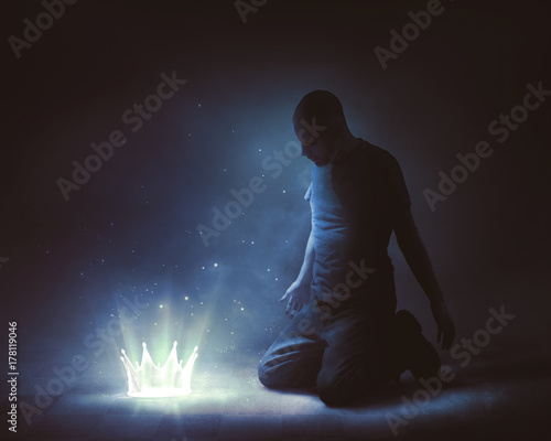 Man offering up a glowing crown