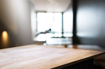 empty wood table in front of blur coffee shop / restaurant background, image can be place product