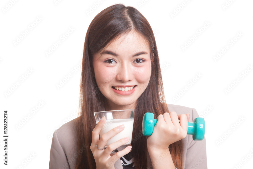 Healthy Asian woman drinking a glass of milk and dumbbell. Healthy Asian woman drinking a glass of milk and dumbbell.