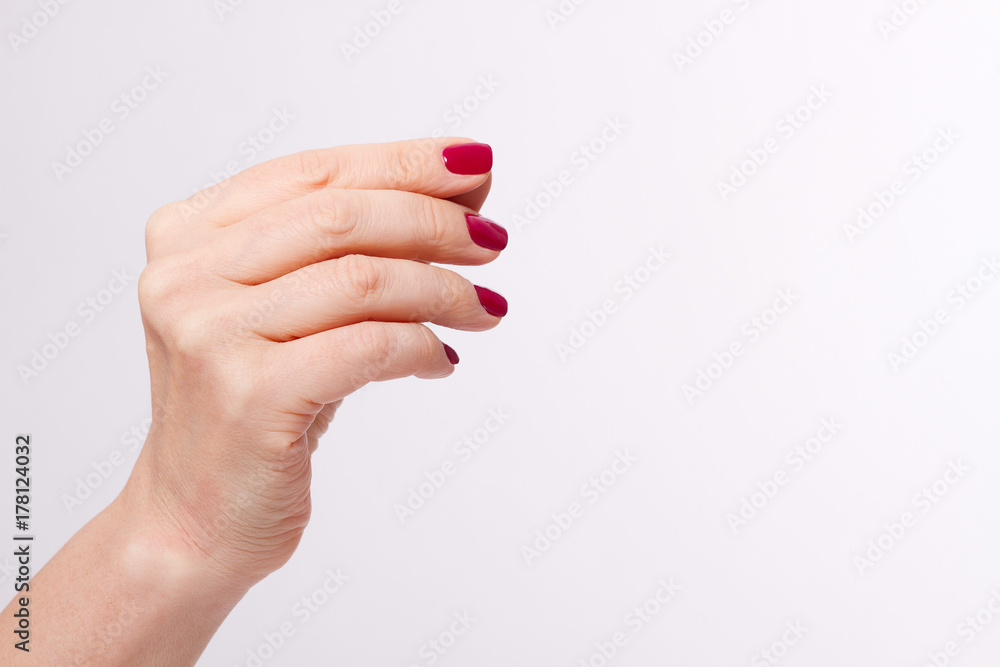 Macro Female hand, arm with red manicure isolated on white background. Mock up and copy space. Place for advertising Macro Female hand, arm with red manicure isolated on white background. Mock up and copy space. Place for advertising