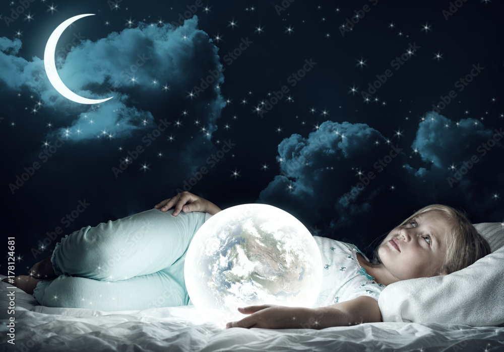 Girl in her bed and glowing globe Girl in her bed and glowing globe